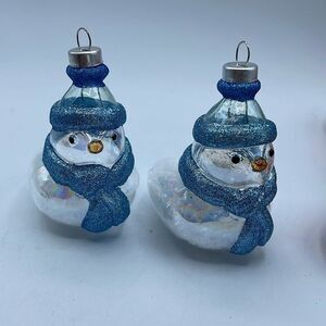 Lot of 2 glass chickadee ornaments with scarves and hats. Faux snow in bottoms.